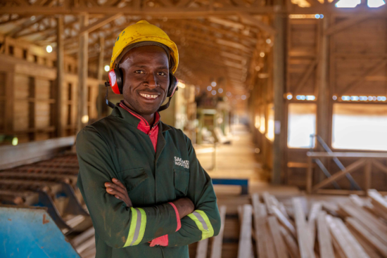 Person facing camera in the wood production facility