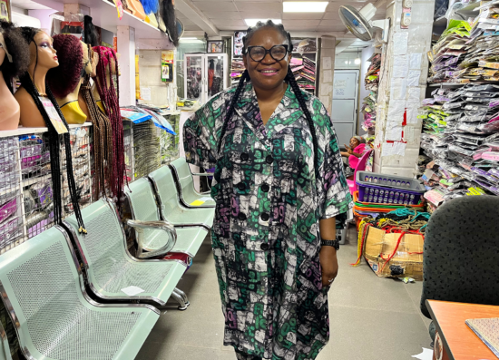 A salesperson smiling at the camera in a shop